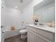 Bright bathroom with white subway tile, shower/tub, white vanity with storage at 4990 Four Strand Ct, St Cloud, FL 34769