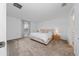 The main bedroom has neutral carpet, a large window and a connecting bathroom, offering a serene space at 4990 Four Strand Ct, St Cloud, FL 34769