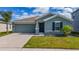 Charming single-story home with a well-maintained lawn, a two-car garage, and stylish exterior finishes at 4990 Four Strand Ct, St Cloud, FL 34769