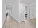 Long hallway with wood look flooring leading to the bathroom, bedroom, and living spaces at 4990 Four Strand Ct, St Cloud, FL 34769