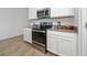 Modern kitchen featuring stainless steel appliances, light countertops, and white cabinets at 4990 Four Strand Ct, St Cloud, FL 34769