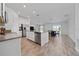 Open kitchen with stainless steel appliances, island, dining area and sliding doors to outside at 4990 Four Strand Ct, St Cloud, FL 34769