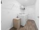 Well-lit laundry room equipped with a washer, dryer, and storage shelves for convenience at 4990 Four Strand Ct, St Cloud, FL 34769