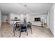 Open-concept floor plan with dining area seamlessly flowing into a cozy living space, perfect for modern living at 4990 Four Strand Ct, St Cloud, FL 34769
