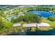 Aerial view showcasing the community amenities, including a pool, tennis courts, volleyball court, and lake access at 5032 Beach River Rd, Windermere, FL 34786
