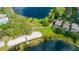 Beautiful aerial view of lakeside homes, beach, and lush green landscape with mature trees at 5032 Beach River Rd, Windermere, FL 34786