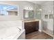 Bathroom featuring a soaking tub, granite countertops, wood flooring, glass enclosed shower, and inset shower shelves at 5032 Beach River Rd, Windermere, FL 34786