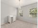 Comfortable bedroom features windows, and chandelier at 5032 Beach River Rd, Windermere, FL 34786