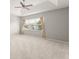 Spacious bedroom features tray ceilings, neutral carpet, and a window at 5032 Beach River Rd, Windermere, FL 34786