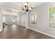 Inviting foyer with white columns, wood-look floors, and ample natural light at 5032 Beach River Rd, Windermere, FL 34786