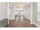 Bright and airy foyer featuring a high ceiling, white columns and trim, and wood-look flooring at 5032 Beach River Rd, Windermere, FL 34786