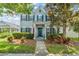 Charming two-story home with blue shutters, an American flag, and a well-manicured front yard at 5032 Beach River Rd, Windermere, FL 34786