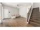 Comfortable living room with wood-look floors and staircase leading to the second level at 5032 Beach River Rd, Windermere, FL 34786