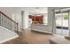 Open living space with a view of the kitchen, stairs to the second floor, and sliding glass doors to the patio at 5032 Beach River Rd, Windermere, FL 34786