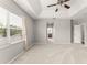 This spacious main bedroom features a tray ceiling, carpeted floors, and an ensuite bathroom for added convenience at 5032 Beach River Rd, Windermere, FL 34786