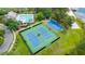 Gorgeous aerial shot of tennis and basketball courts near resort-style pool in a beautiful community at 5032 Beach River Rd, Windermere, FL 34786