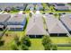 An aerial view of the home showing a backyard with a screened in lanai surrounded by lush green lawns and mature landscaping at 5306 Rochester Pl, St Cloud, FL 34771