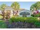 Community Amenity Center with lush tropical landscaping, including palm trees, shrubs, and colorful foliage at 5306 Rochester Pl, St Cloud, FL 34771