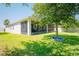 A view of the backyard with a large tree providing shade to the yard with a spacious screened in lanai at 5306 Rochester Pl, St Cloud, FL 34771