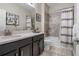 Well-lit bathroom features a vanity with a sink, toilet, and tiled shower-tub combination at 5306 Rochester Pl, St Cloud, FL 34771