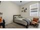 Neutral-toned bedroom with carpet, a gray bed, and a window providing natural light at 5306 Rochester Pl, St Cloud, FL 34771