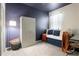 Stylish bedroom with a dark blue accent wall and daybed, complemented by a cozy sitting area at 5306 Rochester Pl, St Cloud, FL 34771