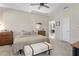 Bright bedroom with neutral walls, carpet, a ceiling fan, and a view of the main living space at 5306 Rochester Pl, St Cloud, FL 34771