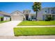 Charming home with a spacious two-car garage, lush lawn, and a beautifully landscaped yard at 5306 Rochester Pl, St Cloud, FL 34771