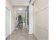 Bright hallway with tile flooring, leading to various rooms in the house at 5306 Rochester Pl, St Cloud, FL 34771