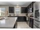 Modern kitchen with stainless steel appliances, dark cabinets, and a large island at 5306 Rochester Pl, St Cloud, FL 34771