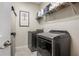 Functional laundry room with modern washer and dryer, ample storage, and neutral decor at 5306 Rochester Pl, St Cloud, FL 34771