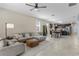 Open-concept living room featuring tile floors, modern furnishings, and abundant natural light at 5306 Rochester Pl, St Cloud, FL 34771