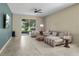 Spacious living room with a comfortable sofa, stylish decor, and access to the patio at 5306 Rochester Pl, St Cloud, FL 34771