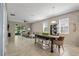 Open-concept living room with dining area, tile floors, and lots of natural light at 5306 Rochester Pl, St Cloud, FL 34771