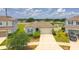 An elevated view of a charming one-story home featuring a two car garage, landscaping, driveway, and partial fencing at 600 Buchannan Dr, Davenport, FL 33837
