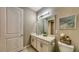 Bathroom boasts a modern vanity, stylish mirror, and ample lighting, all in neutral tones at 600 Buchannan Dr, Davenport, FL 33837