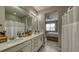 Bathroom featuring a double vanity and an entrance to main bedroom at 600 Buchannan Dr, Davenport, FL 33837