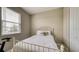 Comfortable bedroom featuring a white metal bed frame, window, closet, and exercise equipment at 600 Buchannan Dr, Davenport, FL 33837