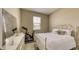 Cozy bedroom with white bed, window, dresser, and exercise bike, creating a functional and inviting space at 600 Buchannan Dr, Davenport, FL 33837