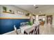 Dining area with decorative blue accent wall, shelving and tile floors leads into the kitchen at 600 Buchannan Dr, Davenport, FL 33837