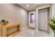 Welcoming entryway with tiled floor, decorative console table, and decorative glass front door at 600 Buchannan Dr, Davenport, FL 33837