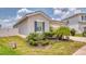 Charming single-story home with stucco siding, lush landscaping, and a convenient attached two-car garage at 600 Buchannan Dr, Davenport, FL 33837