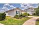 Charming single-story home with stucco siding, lush landscaping, a driveway, and a convenient attached two-car garage at 600 Buchannan Dr, Davenport, FL 33837