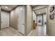 Hallway features tile flooring, neutral paint, and tasteful decor leading to other rooms at 600 Buchannan Dr, Davenport, FL 33837