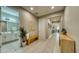 Hallway leads to a full bath, featuring tile floors, neutral paint, and tasteful decor at 600 Buchannan Dr, Davenport, FL 33837