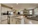 Open concept kitchen with stainless steel appliances and a large island overlooks the living area at 600 Buchannan Dr, Davenport, FL 33837