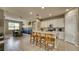 Spacious kitchen with white cabinets, stainless steel appliances, and an island with seating open to dining area at 600 Buchannan Dr, Davenport, FL 33837