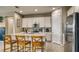 Bright kitchen featuring white cabinets, stainless steel appliances, island with bar seating and tile flooring at 600 Buchannan Dr, Davenport, FL 33837
