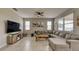 Inviting living room boasts a sectional sofa, large TV, and serene decor and tile floors at 600 Buchannan Dr, Davenport, FL 33837