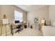 Bright office with neutral walls, window, and desk with computer, artist easels, and art storage, offers versatility at 600 Buchannan Dr, Davenport, FL 33837